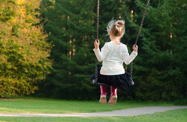 image of little girl on a swing