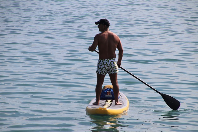 image of man on a paddle board