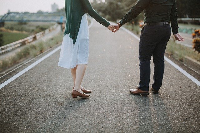 Meadow Brook Hall image twopeople holding hands walking down a path