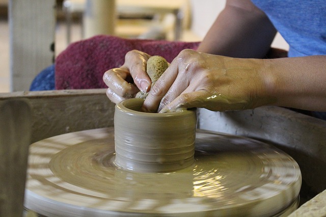image of pottery on a potters wheel for LuLu's Pottery & More with link