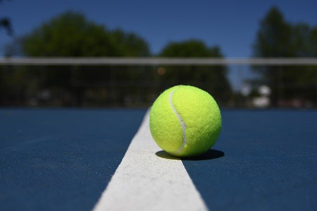 image of tennis ball on tennis court